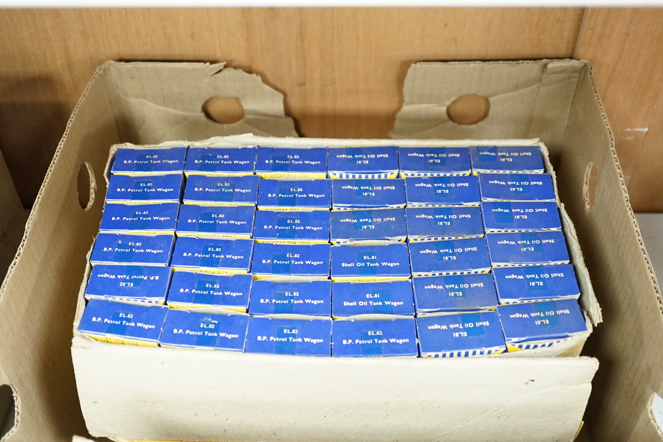 A collection of boxed Lone Star 000 gauge model railway, contained within two original trade boxes with most items, appearing boxed as new, comprising Shell Oil wagons, petrol tank wagons, milk tank wagons, etc. (144 ite